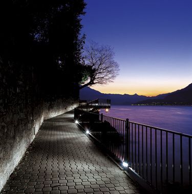 Wide footpath beside water in soft evening light